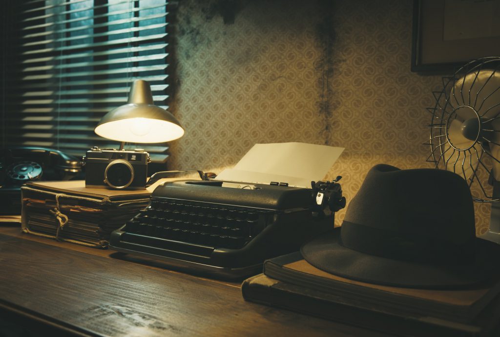 Vintage film noir office desk with old typewriter